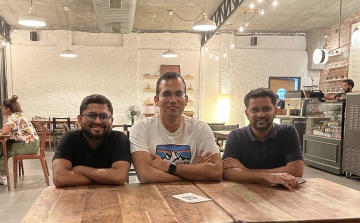 Three friends sitting at a restaurant table