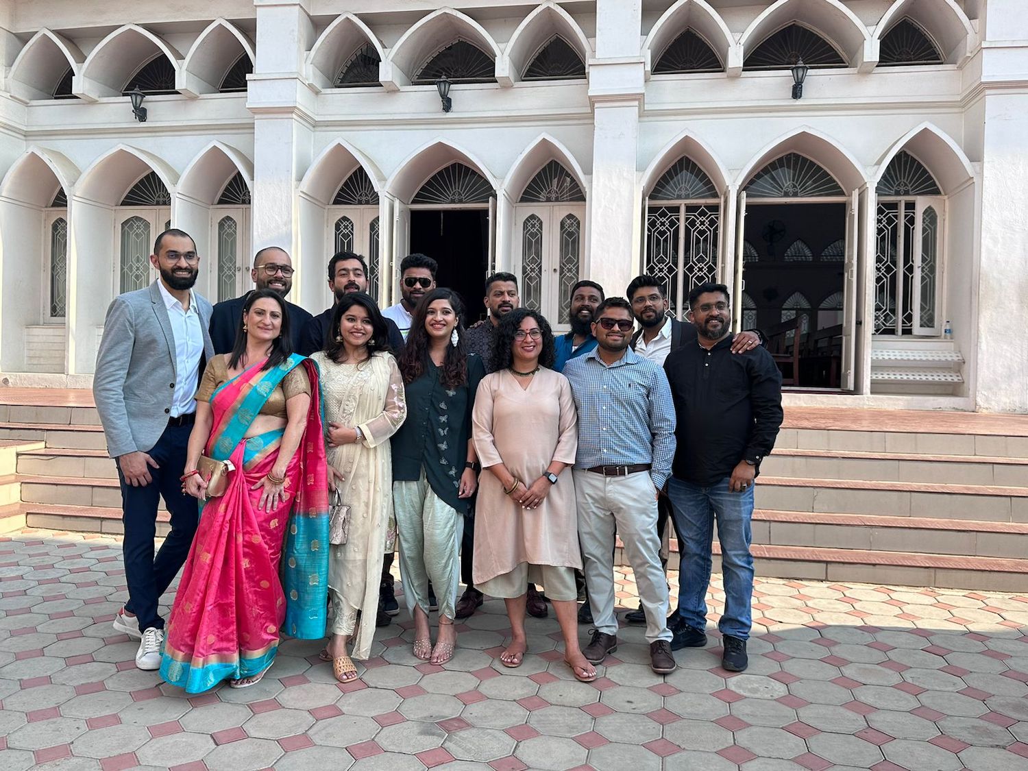 People posing for a photograph outside a church