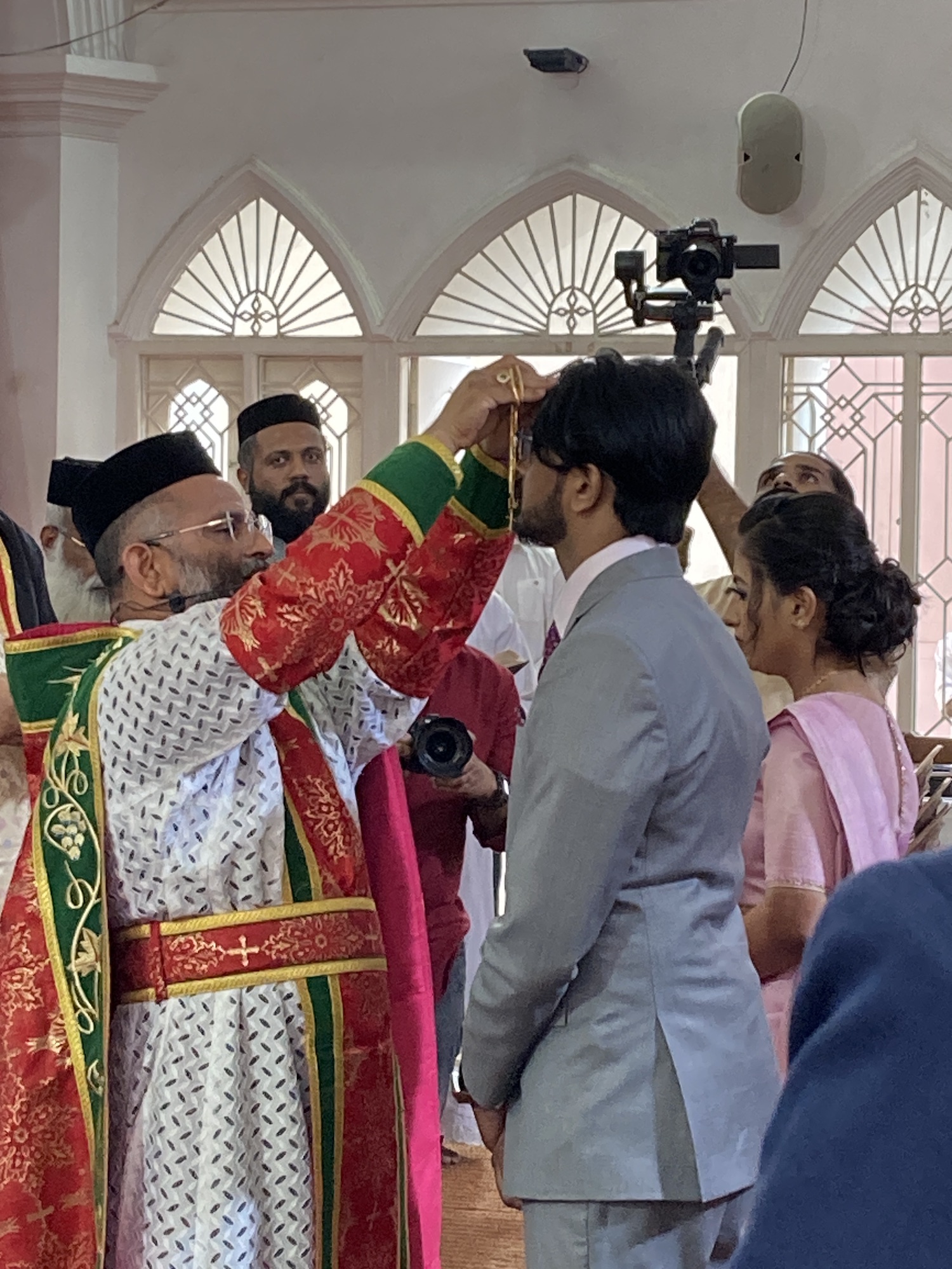 Priest blessing the groom at a Christian wedding